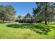 Charming home with brick columns, covered porch, and manicured front lawn showcasing curb appeal at 497 Grey Squirrel Way, Franktown, CO 80116