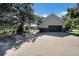 Large garage with a paved driveway, ample parking and mature trees at 497 Grey Squirrel Way, Franktown, CO 80116