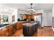 Modern kitchen with wood cabinets, granite countertops, stainless steel appliances, and a central island cooktop at 497 Grey Squirrel Way, Franktown, CO 80116