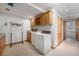 This laundry room features built-in cabinetry, washer and dryer, a utility sink, and space for hanging clothes at 497 Grey Squirrel Way, Franktown, CO 80116