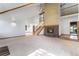 Spacious living room featuring a brick fireplace, staircase, and views of the dining room and outdoor deck at 497 Grey Squirrel Way, Franktown, CO 80116