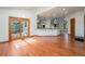 Open living space with hardwood floors, sliding doors to the deck, and a bar-style counter overlooking the kitchen at 497 Grey Squirrel Way, Franktown, CO 80116