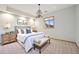 Light and airy main bedroom with a large bed, bench, pendant lighting, and a window at 497 Grey Squirrel Way, Franktown, CO 80116