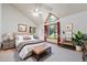 This bright main bedroom features a vaulted ceiling, multiple windows, and a well lit sitting area at 497 Grey Squirrel Way, Franktown, CO 80116