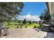 Stamped concrete patio with outdoor seating overlooking a large backyard with scenic views at 497 Grey Squirrel Way, Franktown, CO 80116