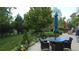 Inviting backyard patio with a table, umbrella, and beautifully landscaped garden at 22386 E Arbor Pl, Aurora, CO 80016