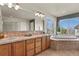 Bathroom with large soaking tub and a double sink vanity providing ample space at 22386 E Arbor Pl, Aurora, CO 80016