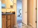 Bathroom vanity and a glimpse into a bedroom with patterned floor tiles at 22386 E Arbor Pl, Aurora, CO 80016