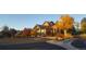 Clubhouse exterior featuring wood beam architectural details and autumn colored trees at 22386 E Arbor Pl, Aurora, CO 80016