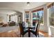 Cozy dining area with large windows, a modern table set, and beautiful views of the backyard at 22386 E Arbor Pl, Aurora, CO 80016