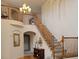 Grand foyer with soaring ceilings, elegant staircase, and stylish chandelier, creating a welcoming atmosphere at 22386 E Arbor Pl, Aurora, CO 80016