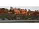 Exterior view of clubhouse on a hill with landscaped yard and walking path at 22386 E Arbor Pl, Aurora, CO 80016