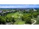 Aerial view of a pristine golf course with manicured fairways, sand traps, and mature trees at 22386 E Arbor Pl, Aurora, CO 80016