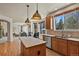 Bright kitchen with stainless appliances, center island, and hardwood floors that open to the living space at 22386 E Arbor Pl, Aurora, CO 80016