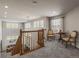 Cozy landing with a chandelier, sitting area, and views of the main floor at 22386 E Arbor Pl, Aurora, CO 80016