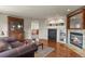 Living room boasting hardwood floors, a cozy fireplace, and a built-in shelving unit at 22386 E Arbor Pl, Aurora, CO 80016