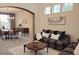 Inviting living room and dining area featuring an archway, neutral colors, and stylish decor at 22386 E Arbor Pl, Aurora, CO 80016