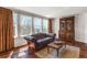 Living room features hardwood floors, lots of sunlight, and a decorative cabinet at 22386 E Arbor Pl, Aurora, CO 80016