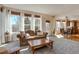 Bright living room with large windows, hardwood floors, and a comfortable seating area at 22386 E Arbor Pl, Aurora, CO 80016