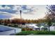 Community pool featuring a staircase and mature trees during golden hour at 22386 E Arbor Pl, Aurora, CO 80016