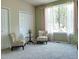 Cozy sitting area with plush chairs, soft carpeting, and large windows at 22386 E Arbor Pl, Aurora, CO 80016
