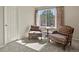 Comfortable sitting room with two chairs, a side table, a sunny window, and natural light at 22386 E Arbor Pl, Aurora, CO 80016