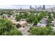 Aerial view showcasing the building's roof, surrounding trees, and urban skyline in the distance at 2862 Champa St, Denver, CO 80205