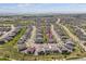 An aerial view of this residential community shows numerous homes on tree-lined streets with views of the surrounding landscape at 22656 E Glidden Dr, Aurora, CO 80016