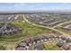 Aerial view featuring community layout with green spaces and interconnected roadways at 22656 E Glidden Dr, Aurora, CO 80016