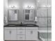 Luxury bathroom with double sinks, granite countertops, decorative mirrors, and a glass-enclosed shower at 22656 E Glidden Dr, Aurora, CO 80016