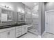 Elegant bathroom with a double vanity, granite countertops, and a glass-enclosed shower with a built-in seat at 22656 E Glidden Dr, Aurora, CO 80016