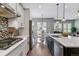 Modern kitchen with breakfast bar, stainless appliances and view to informal dining at 22656 E Glidden Dr, Aurora, CO 80016