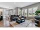 Bright living room with hardwood floors, neutral paint, and large windows at 22656 E Glidden Dr, Aurora, CO 80016