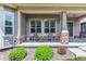 A charming front porch with stone accents, seating, and meticulous landscaping at 22656 E Glidden Dr, Aurora, CO 80016