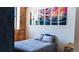Cozy bedroom with a comfortable bed and modern artwork on the wall at 2261 Blake St # 5H, Denver, CO 80205