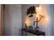 Decorative metal tree art and unique pipe lamp fixtures on a console table at 2261 Blake St # 5H, Denver, CO 80205