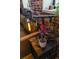 Side table featuring an industrial pipe lamp and a potted plant near the leather couch at 2261 Blake St # 5H, Denver, CO 80205