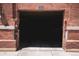 Garage door made of brick shows the entrance to the parking area of a brick building at 2261 Blake St # 5H, Denver, CO 80205
