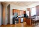 Bright kitchen features stainless appliances, wooden cabinets, and island with seating at 2261 Blake St # 5H, Denver, CO 80205