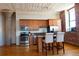 Kitchen island featuring stainless appliances, wooden cabinets, island with seating at 2261 Blake St # 5H, Denver, CO 80205