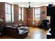 Bright living room with exposed brick, hardwood floors, and a comfortable leather sofa at 2261 Blake St # 5H, Denver, CO 80205