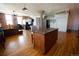 Open-concept living space with hardwood floors, brick walls, and kitchen island at 2261 Blake St # 5H, Denver, CO 80205