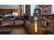 Industrial style lamp next to a leather couch with a view of the kitchen at 2261 Blake St # 5H, Denver, CO 80205