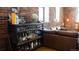 Comfortable living room featuring a well-stocked bar cart and exposed brick wall at 2261 Blake St # 5H, Denver, CO 80205