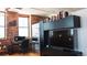 Open-concept living room with a desk and media center and exposed brick walls at 2261 Blake St # 5H, Denver, CO 80205