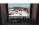 Window view of city buildings with a skull, hour glass, and bar sign in the foreground at 2261 Blake St # 5H, Denver, CO 80205