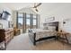Spacious main bedroom with large windows, a vaulted ceiling, carpet and ceiling fan at 18926 W 94Th Ave, Arvada, CO 80007