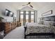 Large primary bedroom features vaulted ceiling, ceiling fan, large windows and neutral carpet at 18926 W 94Th Ave, Arvada, CO 80007
