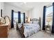 Comfortable bedroom featuring a large window, ceiling fan, and stylish furnishings at 18926 W 94Th Ave, Arvada, CO 80007
