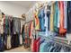 Organized walk-in closet with ample hanging space and shelving for clothing and accessories at 18926 W 94Th Ave, Arvada, CO 80007